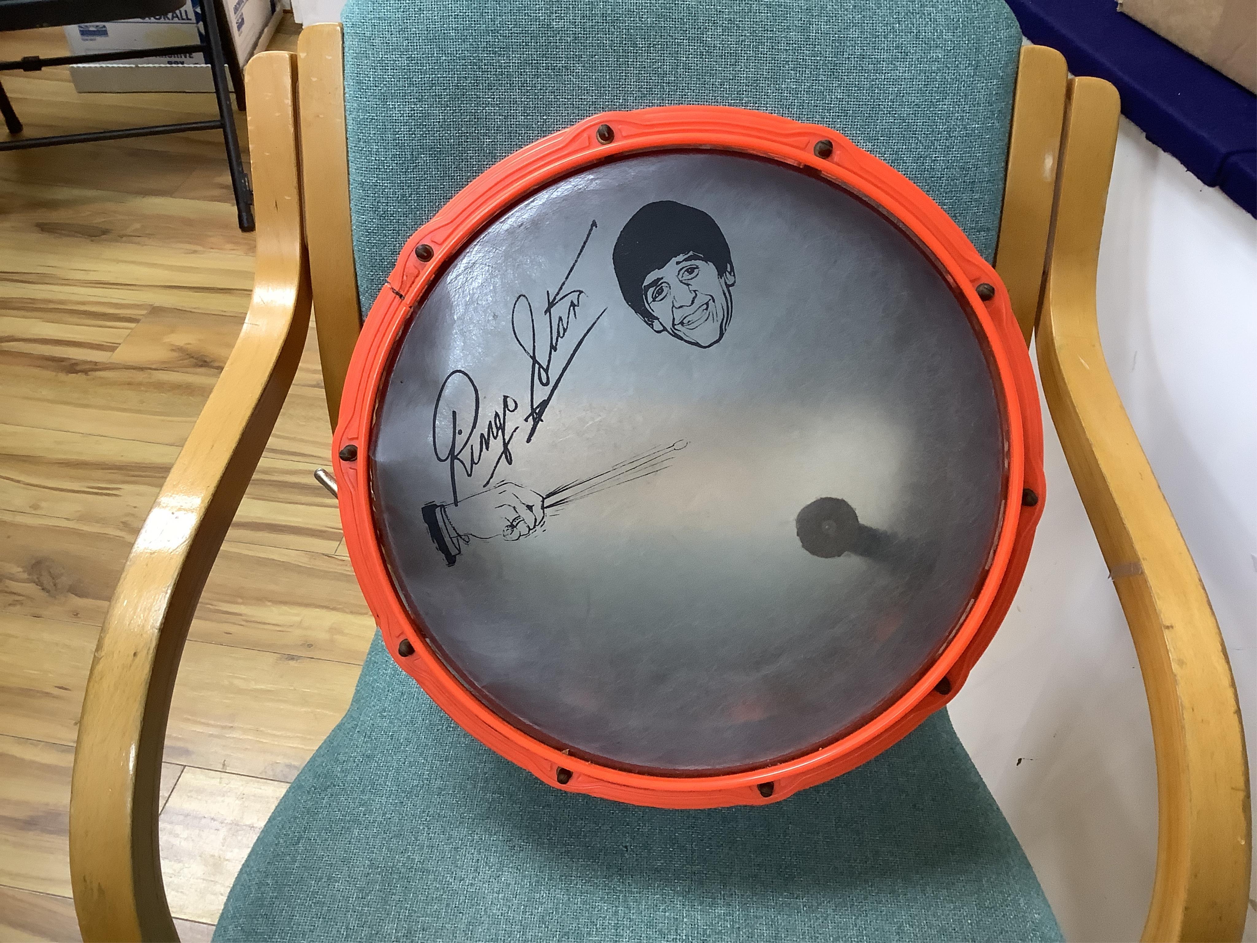 A 1960's Beatles child's plastic drum set in the original card box comprising of a snare drum on a stand, a card cut out bust of Ringo Starr, two 1960s Beatles jigsaws (unchecked) and a Beatles inflatable ball